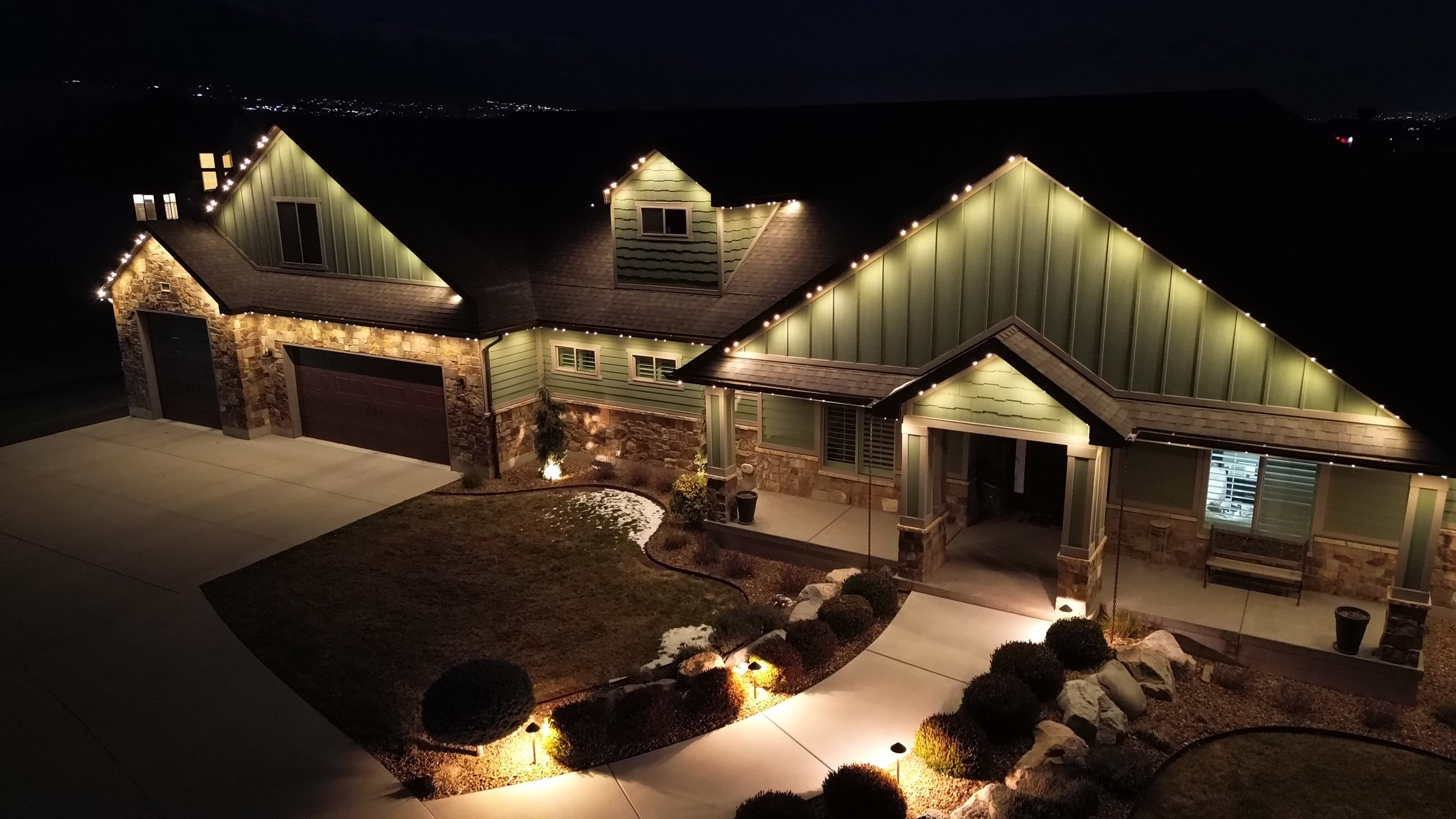 TruLight permanent lighting on stone home at dusk